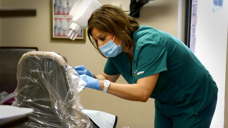 dental hygienist with patient